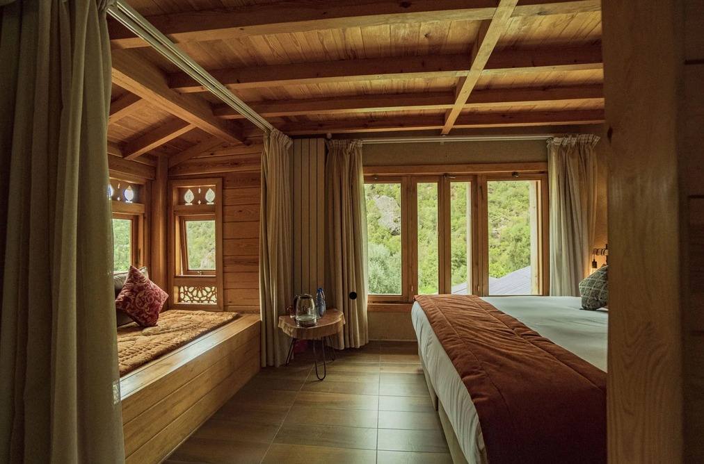 Wooden lodge bedroom with mountain view